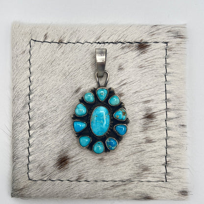 Front view of Sheila Becenti Sonoran Mountain turquoise cluster pendant in sterling silver