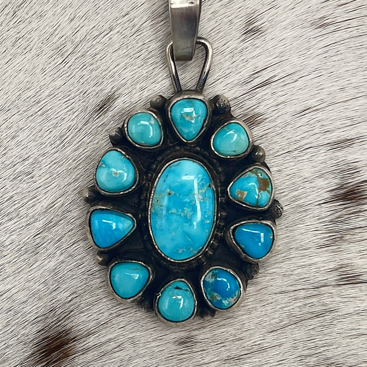 Close-up of Sonoran Mountain turquoise stones with golden-brown matrix in oxidized silver
