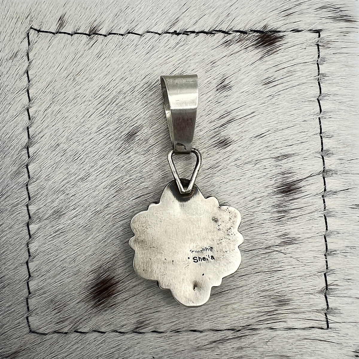 Back of the pendant stamped Sheila and Sterling, the artist's hallmark