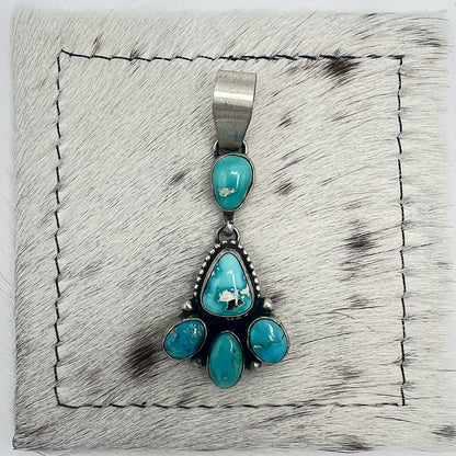 Front view of Betty Tom Blue Bird turquoise drop pendant with wide silver bail