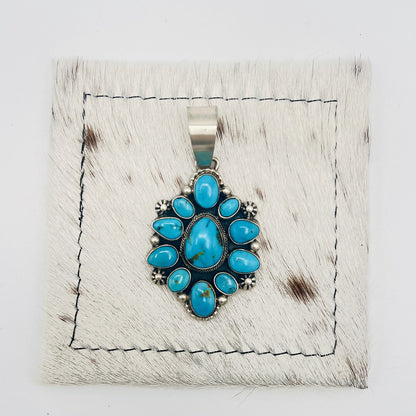 Front view of Kathleen Livingston turquoise cluster pendant with wide silver bail