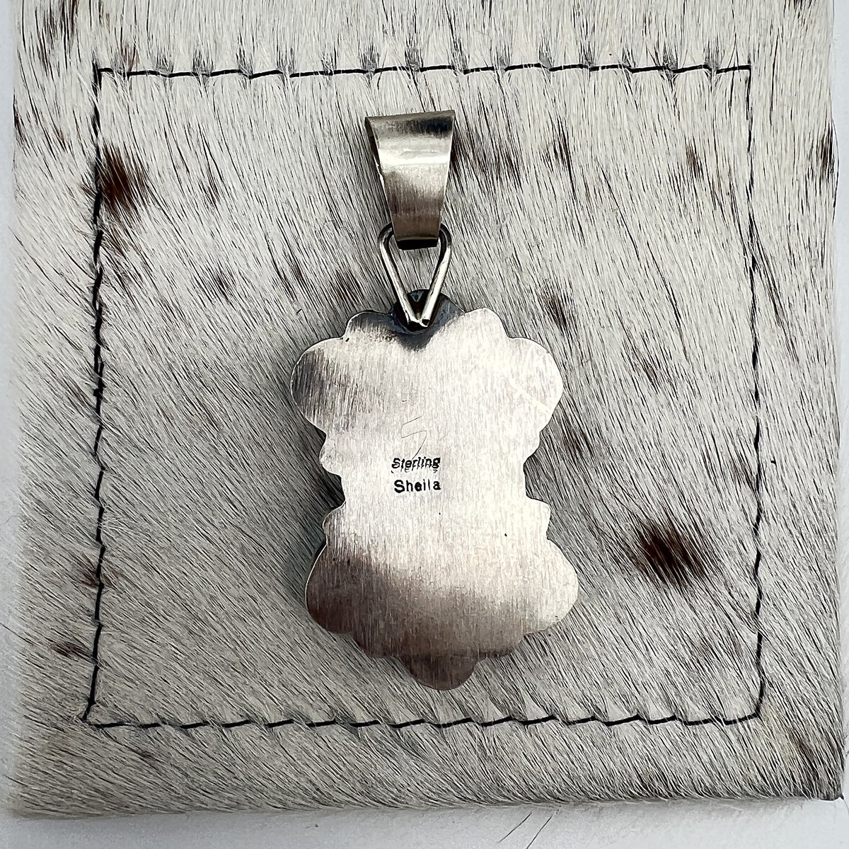 Back of the pendant stamped Sheila and Sterling, the artist's hallmark