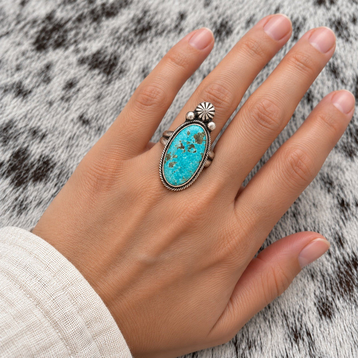 Sierra Nevada Turquoise Tear Ring worn around a finger; approximate scale